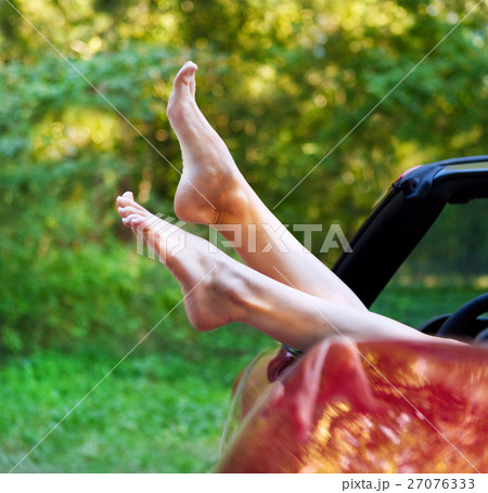 Woman legs out the windows in car Woman legs out the windows in car 27076333