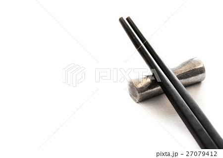 Black wooden chopsticks on metal chopstick rest Black wooden chopsticks on metal chopstick rest 27079412