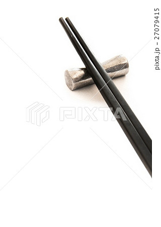 Black wooden chopsticks on metal chopstick rest Black wooden chopsticks on metal chopstick rest 27079415