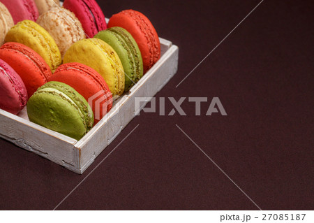 Many traditional french colorful macarons in a box 27085187