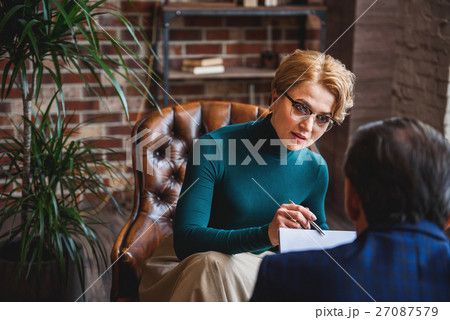 Concentrated female psychologist watching results Concentrated female psychologist watching results 27087579