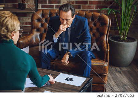 Deeply thoughtful man looking at picture 27087652