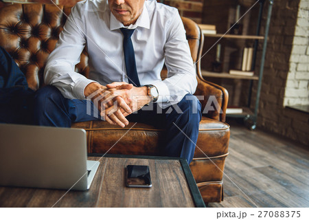 Man sitting on couch afore laptop and mobile Man sitting on couch afore laptop and mobile 27088375
