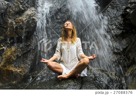 Female Practising Yoga on Waterfall. Stock image. Female Practising Yoga on Waterfall. Stock image. 27088376