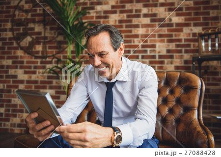 Senior male businessperson holding frame 27088428