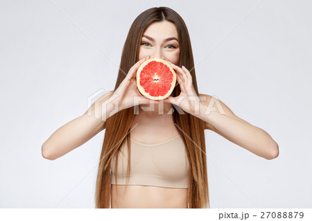 Beautiful Woman with Clean Fresh Skin holding 27088879