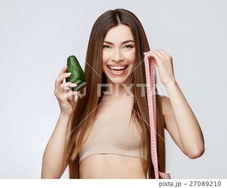 Beautiful Woman with Clean Fresh Skin holding 27089210