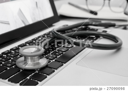 Close-up of stethoscope on laptop computer. Close-up of stethoscope on laptop computer. 27090098