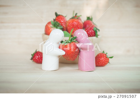 Ceramic toy giving a strawberry to couple for love 27091507