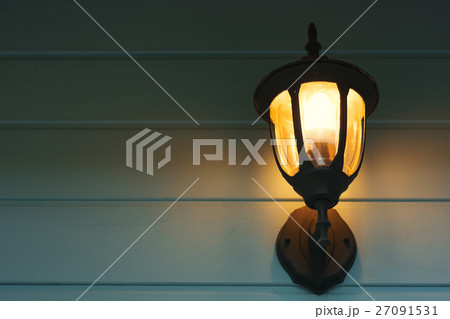 Warm light of external lamps on the house wall 27091531