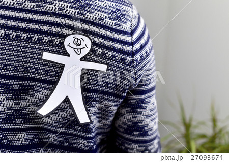 young man with a paper man attached to his back 27093674