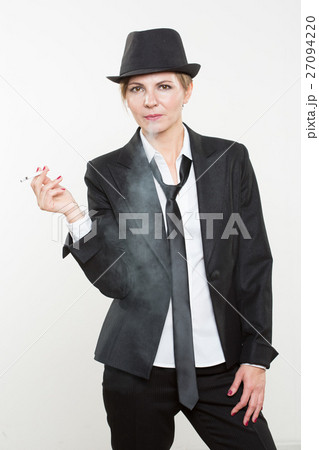 woman smokes a cigarette in business suit woman smokes a cigarette in business suit 27094220