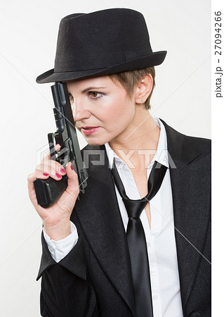 girl gangster holding a gun. Classic suit and hat. girl gangster holding a gun. Classic suit and hat. 27094266