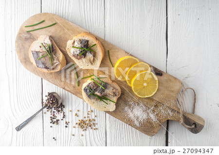 Sandwiches with sardines on a cutting board Sandwiches with sardines on a cutting board 27094347