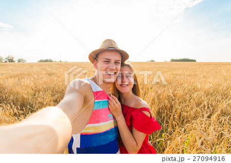 Young couple take photo by mobile phone Young couple take photo by mobile phone 27094916