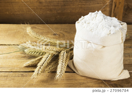 Flour in bag and wheat ears on a wooden background 27096784