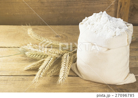 Flour in bag and wheat ears on a wooden background 27096785
