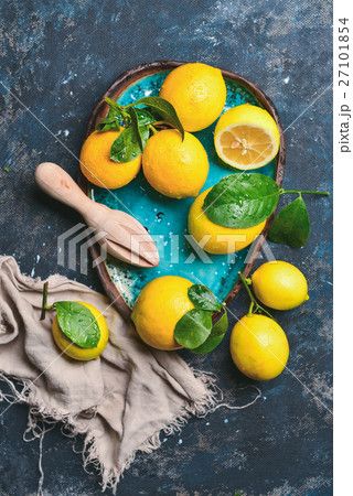 Freshly picked orange lemons with leaves in blue 27101854