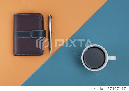 Note book pen and coffee on orange and blue color. 27107147