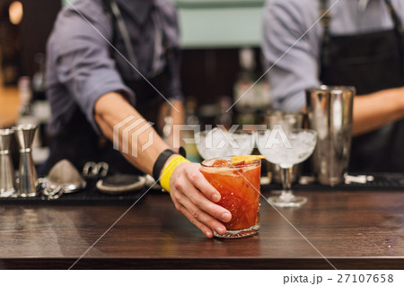 Barman show. Bartender is making cocktail at night 27107658