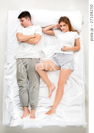 The young lovely couple lying in a bed 27108250