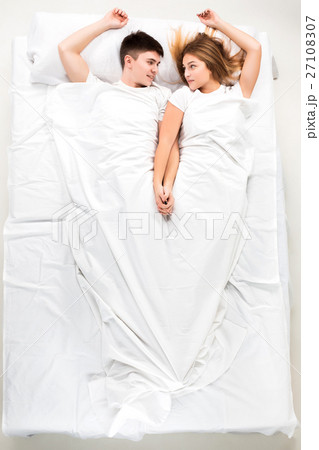 The young lovely couple lying in a bed The young lovely couple lying in a bed 27108307