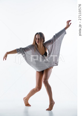 Young beautiful dancer in beige dress dancing on Young beautiful dancer in beige dress dancing on 27110576