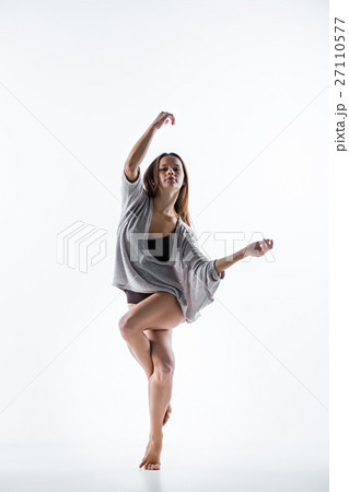 Young beautiful dancer in beige dress dancing on Young beautiful dancer in beige dress dancing on 27110577