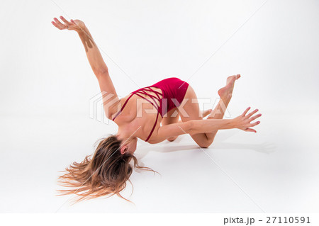 Young beautiful dancer in beige dress dancing on 27110591