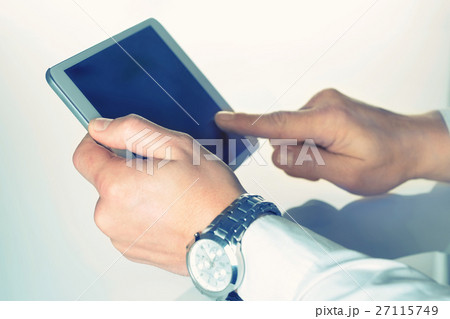 Tablet PC in the hands shot with selective focus Tablet PC in the hands shot with selective focus 27115749