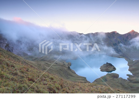 morning fog over alpine lake Schrecksee morning fog over alpine lake Schrecksee 27117299