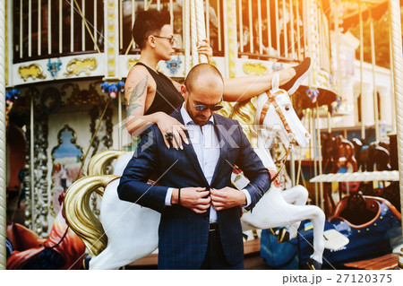 adult man and woman on a carousel 27120375