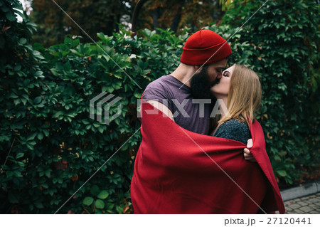 man and woman are kissing in the park man and woman are kissing in the park 27120441