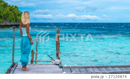 Blond Girl Staying looking into blue ocean, Ampat Blond Girl Staying looking into blue ocean, Ampat 27120874
