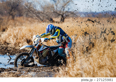 Enduro bike rider stuck in the mud 27125981