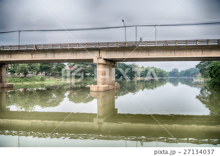 Road bridge across the lake in forests Road bridge across the lake in forests 27134037