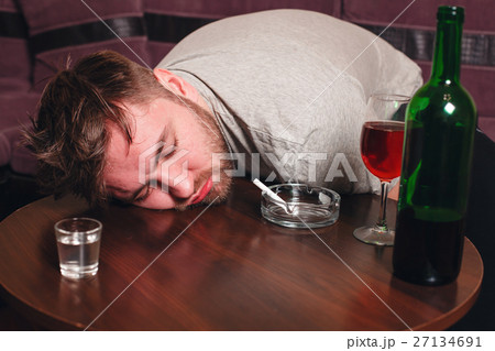 Drunk man sleep on wooden table. Drunk man sleep on wooden table. 27134691