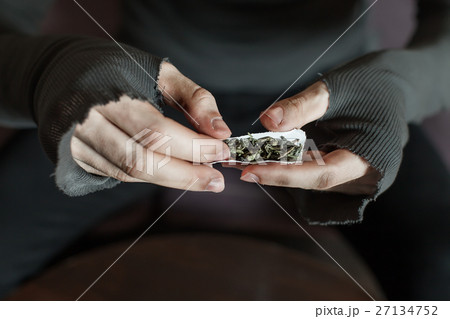 Addict hands making marijuana jamb closeup. 27134752