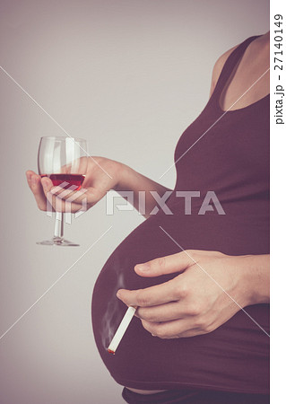 Pregnancy with cigarette and alcohol. Unhealthy. Pregnancy with cigarette and alcohol. Unhealthy. 27140149