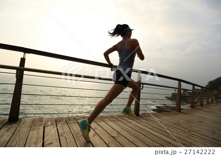 fitness woman trail runner running on seaside 27142222