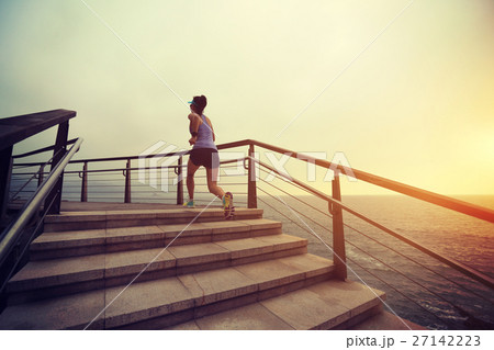 fitness woman trail runner running on seaside 27142223