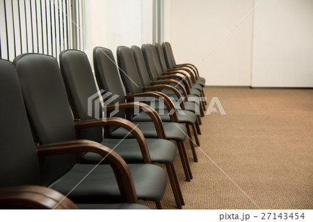 Leather black chairs are standing near the wall Leather black chairs are standing near the wall 27143454