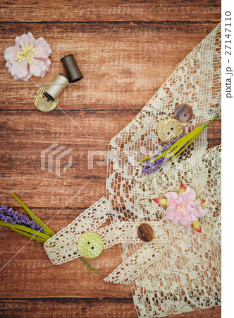 Lace and thread on wooden background 27147110