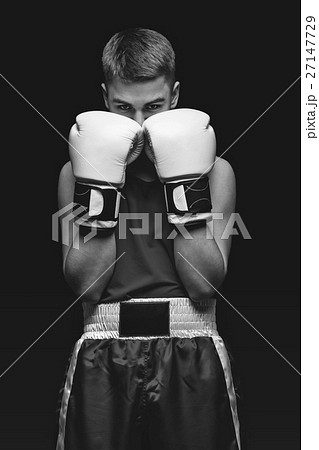 Young boxer sportsman on black background 27147729