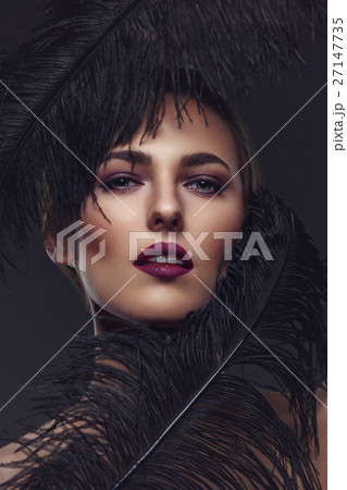 Beautiful girl with black feathers Beautiful girl with black feathers 27147735