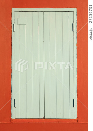 Old wooden window on orange wall. Old wooden window on orange wall. 27159731