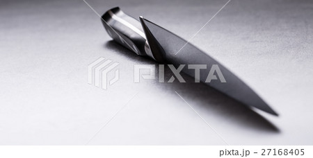 Kitchen knife lying on an modern concrete board. Kitchen knife lying on an modern concrete board. 27168405