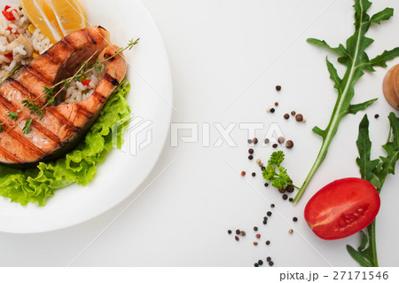 Grilled salmon steak on white table flat lay Grilled salmon steak on white table flat lay 27171546