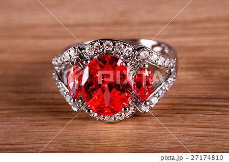 Macro view of silver or white gold ring with red 27174810