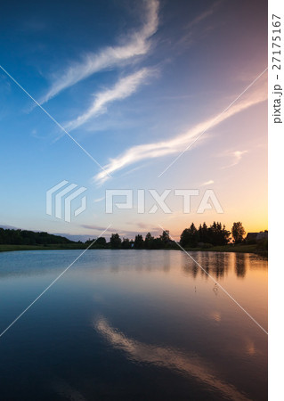Colorful clouds over still lake in evening Colorful clouds over still lake in evening 27175167